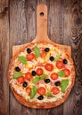 Tasty delicious pizza with salami on the old boards Royalty Free Stock Photo