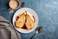 Tasty dessert of baked pears with caramel sauce, cheese cream and almond flakes