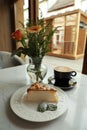 Tasty dessert and cup of fresh coffee on table in cafeteria