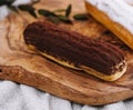Tasty dessert, two eclairs with vanilla and chocolate cream laying