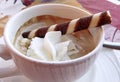 Tasty dessert - Waffle roll in a cup of coffee with cream. Royalty Free Stock Photo