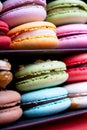 Tasty different colored macarons in black box on light background Royalty Free Stock Photo