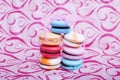 Tasty different colored macarons on pink background Royalty Free Stock Photo