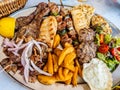 Tasty dish with greek tzatziki sauce, a mixture of various types of grilled meat Royalty Free Stock Photo