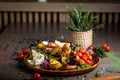 Tasty dish with meat and vegetables, baked pork, cowboy grill, grilled potatoes with sauce. Assorted tasty grilled meat with Royalty Free Stock Photo