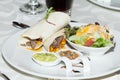 Tasty dish served on the table; Meat burrito with sauces and salad