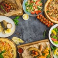 Tasty dishes on table. Grilled pork ribs, pizza, salads, fish and sausages with fried potatoes. Top view. Food frame, restaurant c Royalty Free Stock Photo