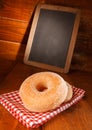 Tasty donut with vanilla sugar and a menu board