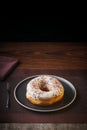 Tasty donuts insulated with white chocolate sprinkled with chocolate chips on a plate on a fine table. Fine pastries, Copy space