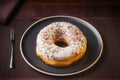 Tasty donuts insulated with white chocolate sprinkled with chocolate chips on a plate on a fine table. Fine pastries