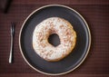 Tasty donuts insulated with white chocolate sprinkled with chocolate chips on a plate on a fine table. Fine pastries