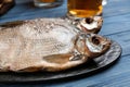 Tasty dried fish on blue wooden table Royalty Free Stock Photo