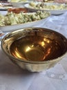 Tasty drink in a golden cup on a laid table