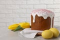 Tasty Easter cake, decorated eggs and flowers on grey table. Space for text Royalty Free Stock Photo
