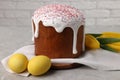 Tasty Easter cake, decorated eggs and flowers on grey table Royalty Free Stock Photo