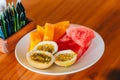 Tasty exotic fruits - ripe passion fruit, mango on breakfast at outdoor restaraunt Royalty Free Stock Photo