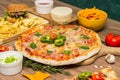 Tasty fast food on table. Pepperoni pizza and pizza Capricciosa , hamburger and potato chips Royalty Free Stock Photo