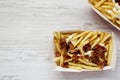 Tasty fastfood: french fries with cheese sauce and bacon in paper boxes. Flat lay, from above, overhead. Copy space Royalty Free Stock Photo