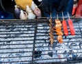 Tasty Filipino meat specialties cooking over charcoal grill.