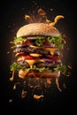 Tasty flying burger on black background. Food levitation. Royalty Free Stock Photo