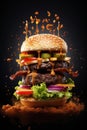 Tasty flying burger on black background. Food levitation. Royalty Free Stock Photo