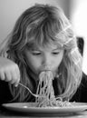 Tasty food, messy child eating spaghetti. Child have a breakfast. Tasty kids breakfast. Childcare and childhood. Close Royalty Free Stock Photo