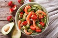 Tasty food: salad with shrimp, avocado and strawberry closeup. h
