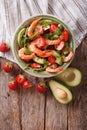 Tasty food: salad with shrimp, avocado and strawberry closeup. v