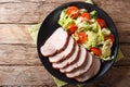 tasty food: sliced pork tenderloin with fresh vegetables close-up. horizontal top view Royalty Free Stock Photo