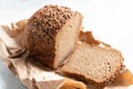 Tasty and fragrant Russian rye Borodino bread lies on craft paper. Freshly baked bread with seasoning coriander on a crust. Sliced