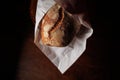 Tasty french bread in paper from bakery closeup