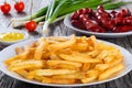 Tasty french fries on plate, on wooden table background Royalty Free Stock Photo