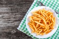 Tasty french fries on plate, on wooden table background Royalty Free Stock Photo