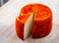 Tasty french goat cheese with pepper at wooden desk