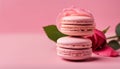 Tasty french macaroons with tender rose on a pink pastel background. Place for text