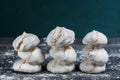 Tasty fresh and airy meringue dessert with nuts on a gray background in icing sugar