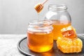 Tasty fresh aromatic honey on grey table