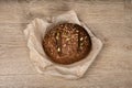 Tasty fresh baked loaf of dark bread with sesame seeds on light background