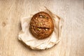 Tasty fresh baked loaf of dark bread with sesame seeds on light background