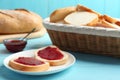 Tasty fresh bread with jam on blue wooden table Royalty Free Stock Photo