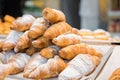 Tasty fresh croissants and rolls on a counter in shop