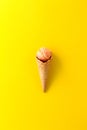 Tasty fresh fruity ice cream in ice cream cone on yellow vibrant