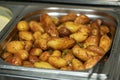 Tasty fresh homemade baked potatoes served on a metal tray. With various herbs, butter, garlic and salt. Gray stone Royalty Free Stock Photo