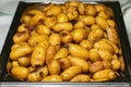 Tasty fresh homemade baked potatoes served on a metal tray. With various herbs, butter, garlic and salt. Gray stone Royalty Free Stock Photo