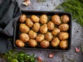 Tasty fresh homemade baked potatoes served on a metal tray. With various herbs, butter, garlic, salt Royalty Free Stock Photo