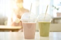 Tasty fresh milk shakes in plastic cups in cafe Royalty Free Stock Photo