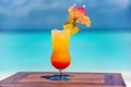 Tasty fresh pineapple cocktail on the wooden table at the beach with ocean Royalty Free Stock Photo