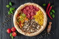 Tasty fresh pizza with four different pieces in one on wooden background. Top view of big pizza Royalty Free Stock Photo