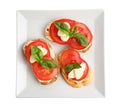 Tasty fresh tomato bruschettas on background, top view