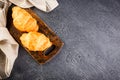 Freshly baked croissants on wooden cutting board, top view Royalty Free Stock Photo